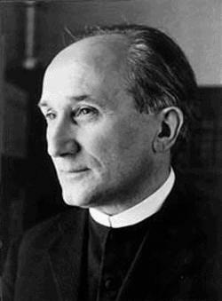 Romano Guardini around 1920, a thin, severe priest in clerical collar, photographed in soft light.