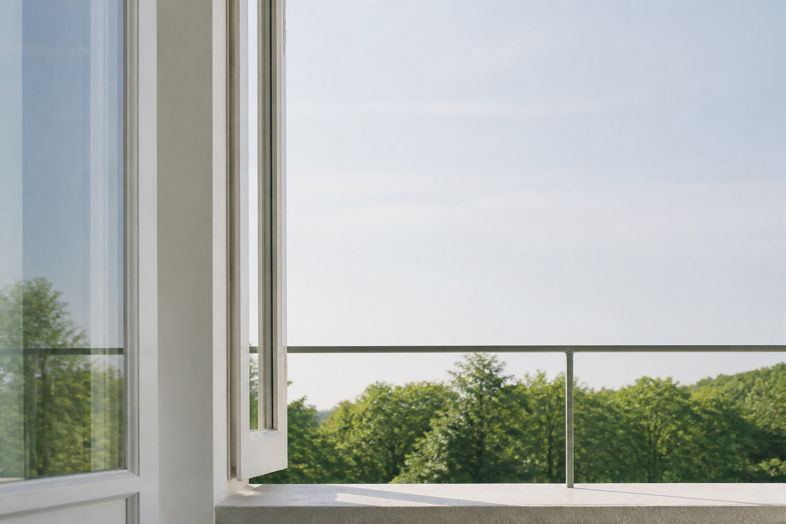A pale summer morning seen from inside: an open window, clean plaster, a balcony rail, and one line of green beyond.